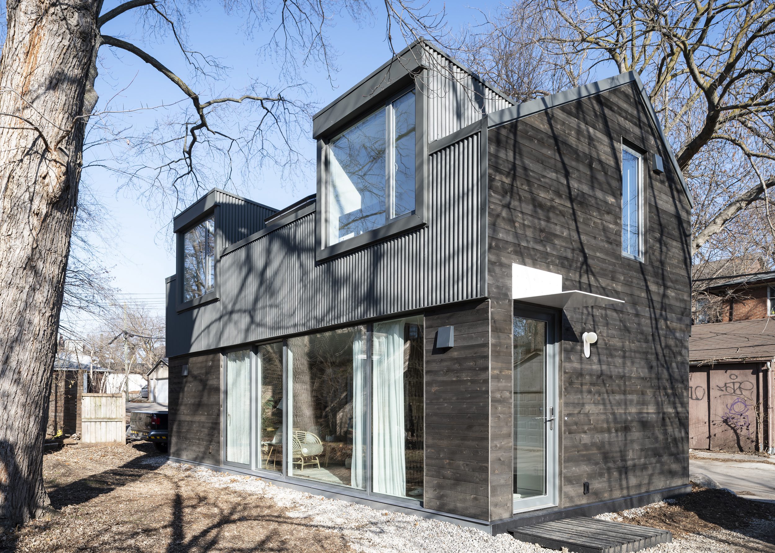 Parkdale Toronto laneway house aged wood exterior