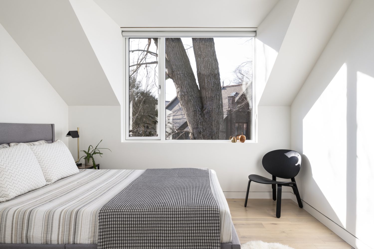 Beautiful laneway house in parkdale, Toronto. Second floor bedroom bed and window